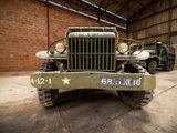 an old military truck parked in a garage