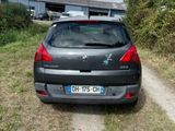 a car that is parked on the side of a dirt road