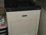 a printer sitting on top of a desk next to a stack of boxes