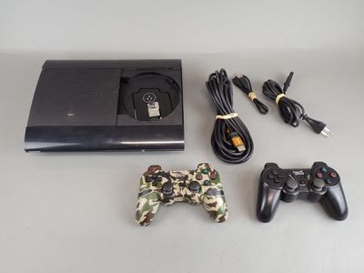 a video game console with two controllers and a charger