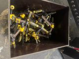 yellow and black tools are in a metal box on a concrete floor