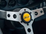 a close up of a steering wheel with a yellow button