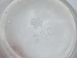 a close up of a white vase with a red handle