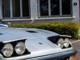 a silver car that is parked in front of a building