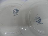 two white plates with blue designs on them