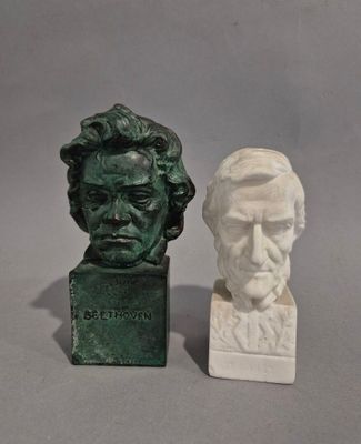 two busts of men sitting next to each other