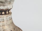 a close up of a vase with holes in it