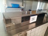 a stainless steel counter top with a sign on it