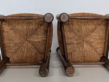 pair of vintage rattan chairs with wooden legs and arms