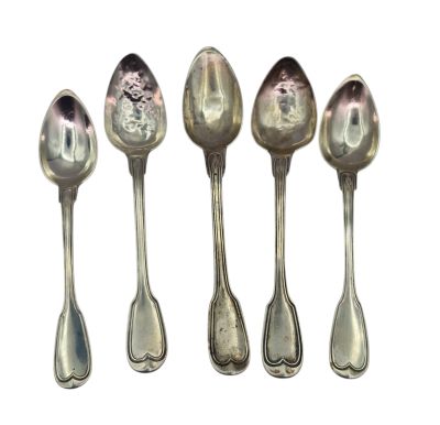 six silver spoons are lined up in a row on a white surface