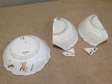 three pieces of white porcelain sitting on a table