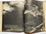 an open book with a picture of a plane flying in the sky