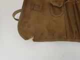 a brown bag that is sitting on a white table