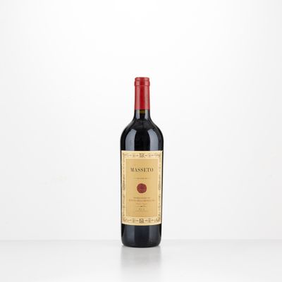 a bottle of red wine sitting on top of a table