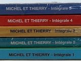 five books stacked on top of each other on a table