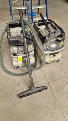 two vacuums that are sitting on the floor next to each other