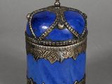 blue and silver box with a crown on top on a gray surface