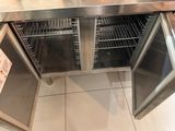 a stainless steel counter top with two open doors
