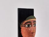 an image of a sculpture of a woman ' s face on a black stand