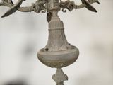a chandelier that has a bird on top of it
