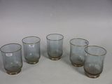 six glasses are lined up in a row on a white surface