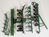 a picture of a toy farm equipment set up on a white surface