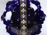 a blue glass bowl with a gold trim around it