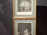 two framed pictures of a woman and a child on a table