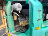a close up of a green and yellow truck with its door open