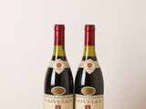 two bottles of wine sitting on top of a wooden table