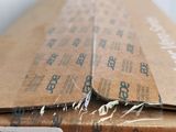 a cardboard box with a pair of scissors inside of it