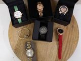 four different watches in a box on a table