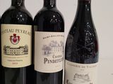 several bottles of wine are lined up on a table