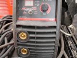 an image of a welding machine sitting on top of a pile of wires