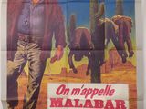 une vieille affiche de cinéma représentant un homme marchant dans le désert