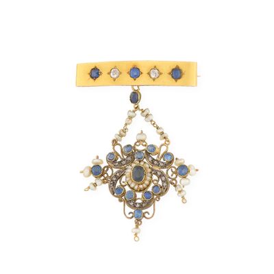 une image d'une broche « broochle » dorée et bleue ornée de perles