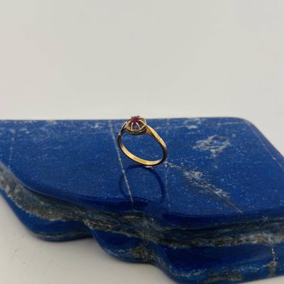 an image of a diamond ring on a blue stone