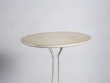 a white table with two legs and a round table top