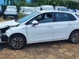 a picture of a white car that has been badly damaged