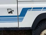 a white truck with a blue stripe on the side of it