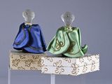 two figurines that are sitting on top of a table