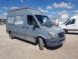 a grey van that is parked in a parking lot