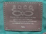 an image of a close up of a purse with a tag on it
