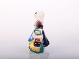 a figurine of a woman with a dog on her back