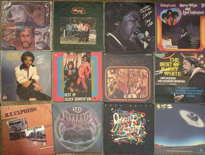 many different album covers on the floor of this room