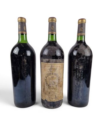 three bottles of wine sitting next to each other on a white surface