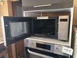 a microwave that is sitting on top of a stove