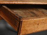 close up of a wooden desk with a drawer underneath it