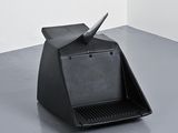 a black object sitting on the floor in a room