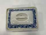 a small blue and white plate with a fish on it